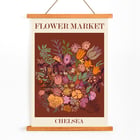 Colorful floral artwork by Moryarty titled Flower Market Chelsea Poster titled Flower Market - Chelsea by Moryarty featuring various colorful flowers on a brown background.