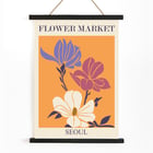 Flower Market - Seoul 2 by Moryarty featuring colorful illustrated flowers Poster featuring three stylized flowers on an orange background with text Flower Market Seoul titled Seoul 2 by Moryarty