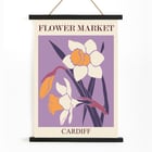 Illustration of yellow and white flowers by the artist Moryarty titled Flower Market - Cardiff Poster titled Flower Market - Cardiff by Moryarty featuring illustrated daffodils on a purple background.