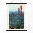 Skyline view of New York with bold USA letters in artwork by U.S. Information Agency USA New York Department of Commerce Poster titled New York by U.S. Information Agency depicting a cityscape view with skyscrapers and large red letters USA.