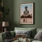 Large Buddha by Kinbei Kusakabe featuring a serene statue with two people standing in front. Poster of Large Buddha with two people in front by artist Kinbei Kusakabe featuring a serene statue surrounded by flowers.