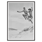 Acrobatic jump at the beach by Tivoli stars Acrobatics at the Beach Poster of Acrobatics at the Beach by Two Tivoli Stars featuring two people in swimsuits jumping on a sandy beach.