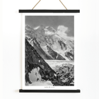 Black and white photograph of Broad Peak by Vittorio Sella featuring snow-covered mountains and climbers in the foreground Poster of snowy Broad Peak mountain captured by Vittorio Sella with mountaineers climbing amidst rocky terrain and glacier