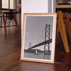 Lisbon Bridge Black and White Picture featuring by Raphael Alves Poster featuring Lisbon Bridge Black & White Picture with a framed photograph of a suspension bridge and a sailboat in the water