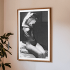 Before going to bed by Michael Heumuller depicts a person gracefully removing a garment Poster of a person removing a shirt in a dimly lit room titled Before going to bed by Michael Heumuller.