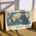 Map artwork The Floor of the Oceans by Bathymetric Map of the World. Poster featuring a world map highlighting ocean floors titled The Floor of the Oceans.