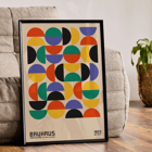 Colorful geometric shapes in Bauhaus Poster 11 inspired by the Weimar Exhibition. Bauhaus Poster 11 features colorful geometric shapes in a grid pattern inspired by the Weimar Exhibition artwork.