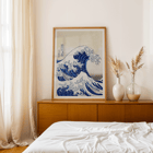 The Great Wave off Kanagawa by Katsushika Hokusai features a dramatic large wave towering over small boats. The Great Wave off Kanagawa poster by Katsushika Hokusai depicting a large wave threatening boats with Mount Fuji in the background.