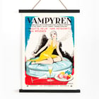 Poster of Vampyren featuring a woman in a yellow dress with A Daughter of Destiny by Eric Rohman. Poster titled A Daughter of Destiny by Eric Rohman features a stylish woman in a yellow dress sitting on a circular seat.
