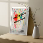 Amsterdam Color City by Hans Cornelissen vibrant abstract splatter artwork poster Poster of abstract paint splatters with text Amsterdam kleuren stad by Hans Cornelissen in bold over colorful background.