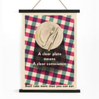 Poster by James Fitton promoting mindful eating habits titled A Clear Plate Means a Clear Conscience Poster showing an empty plate with cutlery on a checkered tablecloth featuring the text A Clear Plate Means a Clear Conscience by James Fitton
