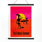The Endless Summer surfers walking on beach at sunset Poster featuring surfers carrying boards against a stylized sunset backdrop titled The Endless Summer