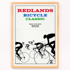 Cyclists racing illustration by Karlis Smiltens titled Redlands bicycle classic Poster of cyclists in race with title Redlands Bicycle Classic by Karlis Smiltens in red, blue, and green text on a white background.