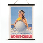 Artwork by Louis Icart titled Monte Carlo featuring two women in swimsuits sitting on a large ball. Poster showing two women seated on a large ball at the beach with text Monte Carlo by Louis Icart.