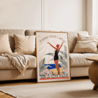 Woman enjoying sunny beach scenery Cote d'Azur by Roger Broders. Poster of a woman in a swimsuit with arms raised at the beach surrounded by flowers Artwork Cote d'Azur by Roger Broders