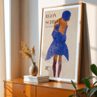 Egon Schiele exhibition poster featuring artwork Red Hair Blue Hat Exhibition poster featuring a woman with red hair in a blue dress and hat by Egon Schiele titled Red Hair Blue Hat