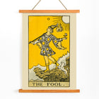 The Fool tarot card illustration by Lauron William de Laurence featuring a whimsical character and a small dog on a cliff. The Fool tarot card poster by Lauron William de Laurence depicts a figure on a cliff with a dog beneath a bright yellow background.