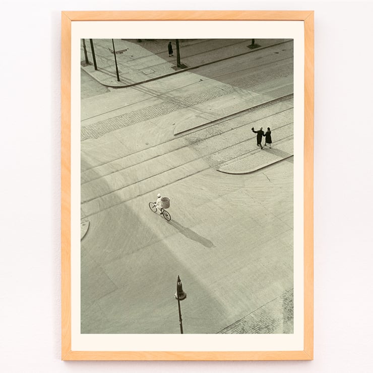 Cyclist on an empty street at dawn captured in artwork 7 AM New Years Morning by László Moholy-Nagy Poster of a black and white city street scene with a cyclist by László Moholy-Nagy titled 7 A.M. New Year’s Morning