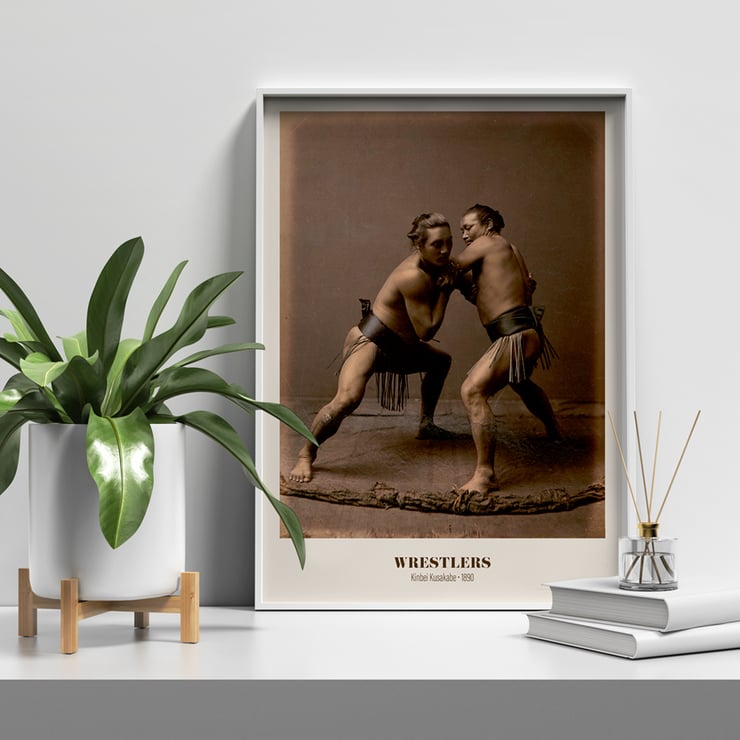 Wrestlers in a traditional pose by Kinbei Kusakabe artwork titled Wrestlers Poster of two sumo wrestlers in traditional attire engaged in a match titled Wrestlers by Kinbei Kusakabe.