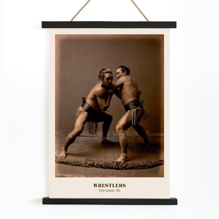 Wrestlers in a traditional pose by Kinbei Kusakabe artwork titled Wrestlers Poster of two sumo wrestlers in traditional attire engaged in a match titled Wrestlers by Kinbei Kusakabe.