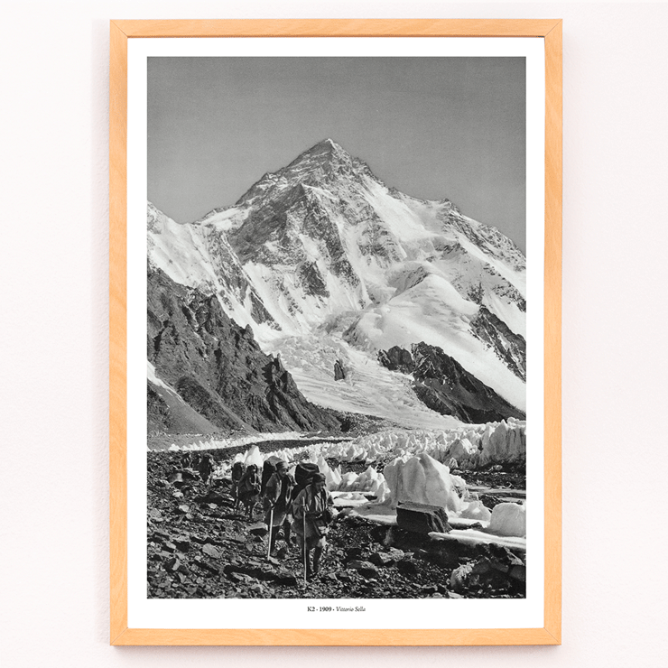 Glacier expedition near K2 by Vittorio Sella Le pic K2 vue prise du glacier Godwin-Austen Poster showing mountaineers trekking toward K2 over a rocky glacier field in black and white by Vittorio Sella titled Le pic K2 vue prise du glacier Godwin-Austen