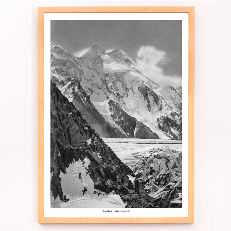 Black and white photograph of Broad Peak by Vittorio Sella featuring snow-covered mountains and climbers in the foreground Poster of snowy Broad Peak mountain captured by Vittorio Sella with mountaineers climbing amidst rocky terrain and glacier