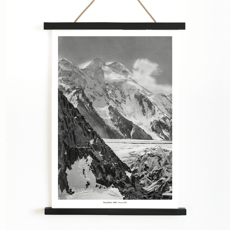 Black and white photograph of Broad Peak by Vittorio Sella featuring snow-covered mountains and climbers in the foreground Poster of snowy Broad Peak mountain captured by Vittorio Sella with mountaineers climbing amidst rocky terrain and glacier
