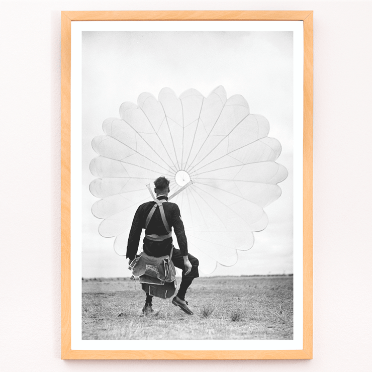 Air force parachuter landing by Ray Olsen Poster of an air force parachuter standing on ground with deployed parachute by Ray Olsen titled Air force parachuter