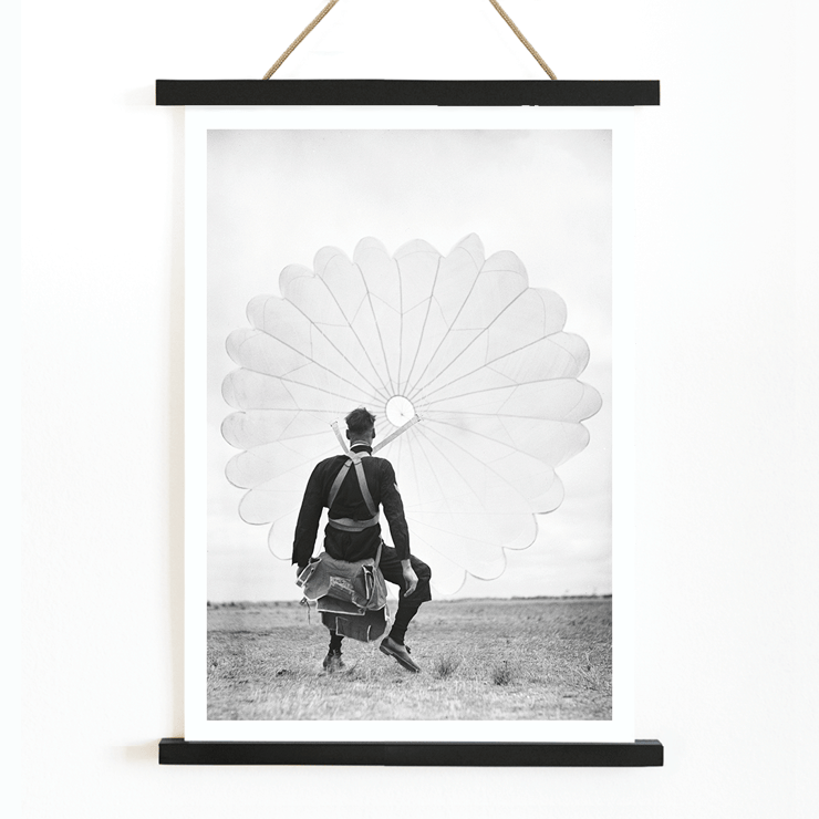 Air force parachuter landing by Ray Olsen Poster of an air force parachuter standing on ground with deployed parachute by Ray Olsen titled Air force parachuter