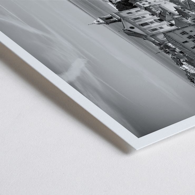 Lisbon Old City Landscape by Black & White Picture 1 depicts historic buildings rooftops and ocean view Poster featuring Lisbon Old City Landscape Black & White Picture 1 with a view of historical buildings and waterfront.