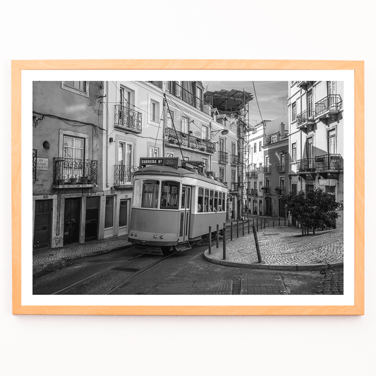 Lisbon Tramway 28 by Black & White Picture showing historic tram in Lisbon street scene Poster featuring Lisbon Tramway 28 Black & White Picture showing the tram navigating through narrow, historic streets with cobblestone pathways.