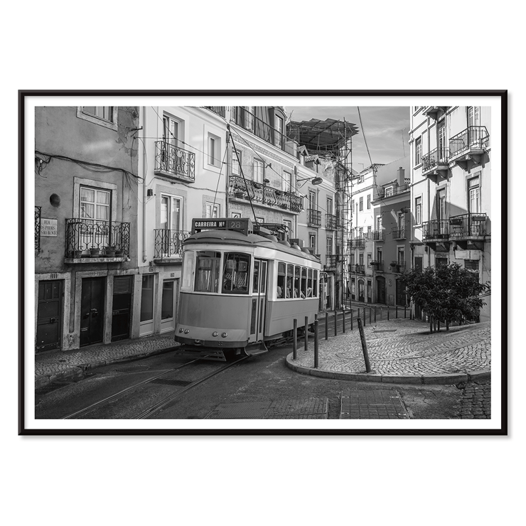 Lisbon Tramway 28 by Black & White Picture showing historic tram in Lisbon street scene Poster featuring Lisbon Tramway 28 Black & White Picture showing the tram navigating through narrow, historic streets with cobblestone pathways.