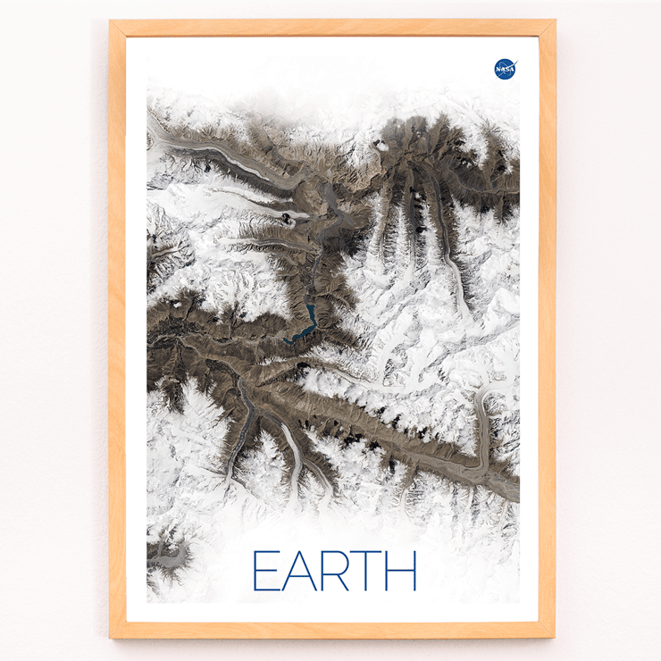 A stunning view of Earth's snowy mountain ranges by NASA from the artwork Earth 1 Poster titled Earth by NASA depicting a detailed and high-resolution satellite image of rugged terrain with snow-covered peaks