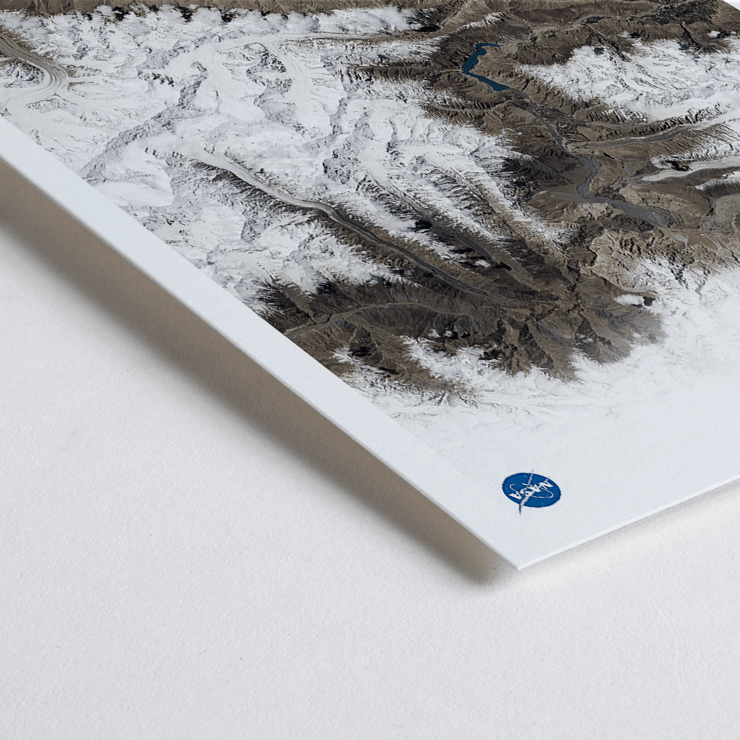 A stunning view of Earth's snowy mountain ranges by NASA from the artwork Earth 1 Poster titled Earth by NASA depicting a detailed and high-resolution satellite image of rugged terrain with snow-covered peaks