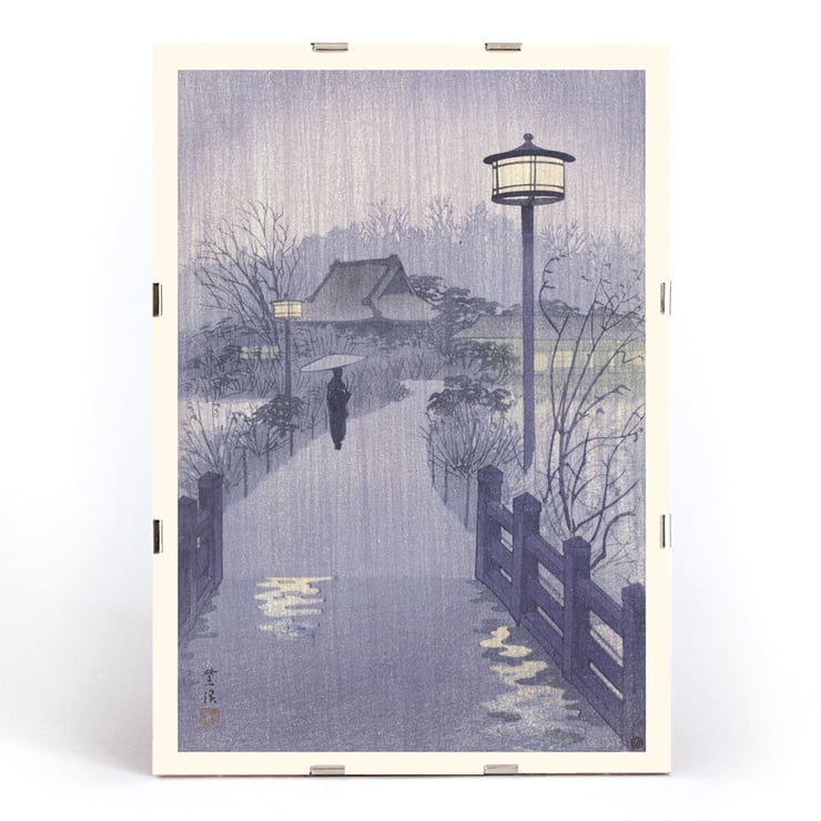 Illustration of a rainy evening at Shinobazu pond by Kasamatsu Shirô showing a person with an umbrella walking near a lamppost. Poster of a serene evening scene with a lone figure by Shinobazu pond Artist Kasamatsu Shirô Artwork Evening rain