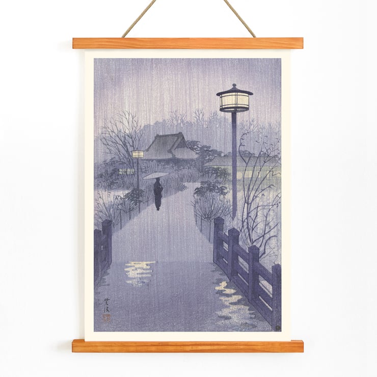 Illustration of a rainy evening at Shinobazu pond by Kasamatsu Shirô showing a person with an umbrella walking near a lamppost. Poster of a serene evening scene with a lone figure by Shinobazu pond Artist Kasamatsu Shirô Artwork Evening rain