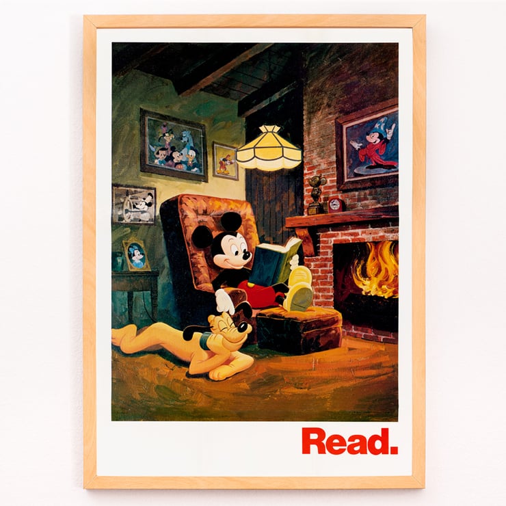 Mickey Mouse reading by the fireplace Read by American Library Association U.S. Information Agency Poster featuring Mickey Mouse reading by the fireplace with Pluto titled Read American Library Association by US Information Agency