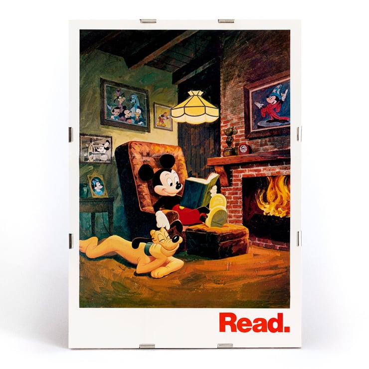 Mickey Mouse reading by the fireplace Read by American Library Association U.S. Information Agency Poster featuring Mickey Mouse reading by the fireplace with Pluto titled Read American Library Association by US Information Agency