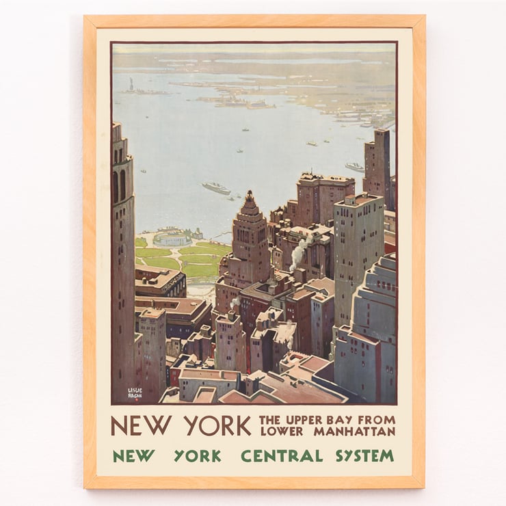 Aerial view of Lower Manhattan and Upper Bay painted by Leslie Ragan in the artwork New York Central System. Poster of New York skyscrapers and bay view from Lower Manhattan by artist Leslie Ragan titled New York Central System.