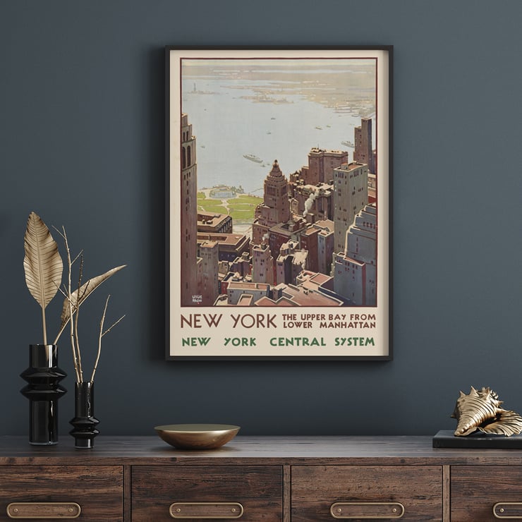 Aerial view of Lower Manhattan and Upper Bay painted by Leslie Ragan in the artwork New York Central System. Poster of New York skyscrapers and bay view from Lower Manhattan by artist Leslie Ragan titled New York Central System.