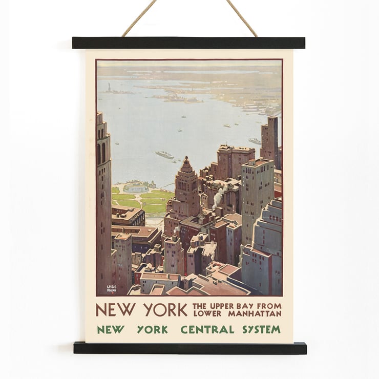 Aerial view of Lower Manhattan and Upper Bay painted by Leslie Ragan in the artwork New York Central System. Poster of New York skyscrapers and bay view from Lower Manhattan by artist Leslie Ragan titled New York Central System.