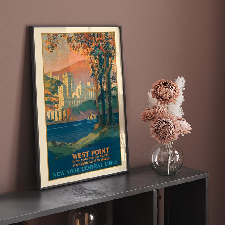 Painting of West Point United States Military Academy in the highlands of the Hudson by Frank Hazell. A colorful poster by Frank Hazell depicting West Point Military Academy by the Hudson River surrounded by trees and mountains.