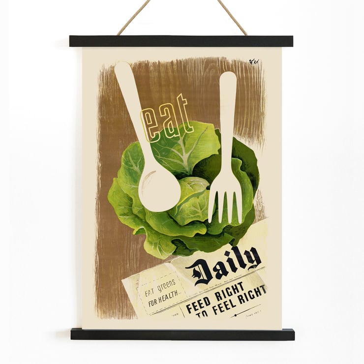 Artwork Eat Greens for Health – Feed Right to Feel Right by Hans Schleger showing a lettuce head with utensils overlay. Poster titled Eat Greens for Health – Feed Right to Feel Right by Hans Schleger featuring lettuce and utensils promoting healthy eating.