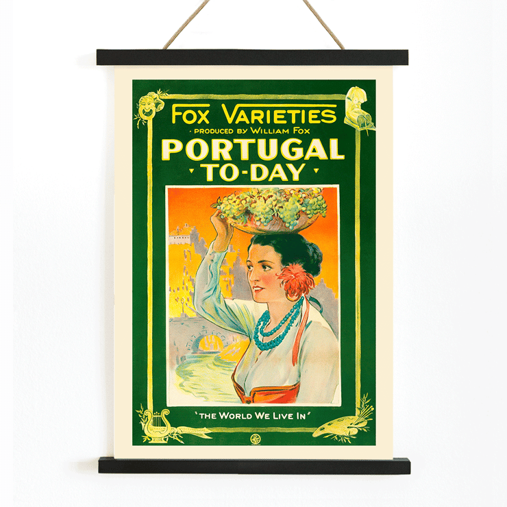 Colorful vintage poster of a woman carrying grapes by William Fox titled Portugal Today Poster of Portugal Today by Anonymous featuring a woman in traditional attire carrying fruit on her head with colorful backdrop