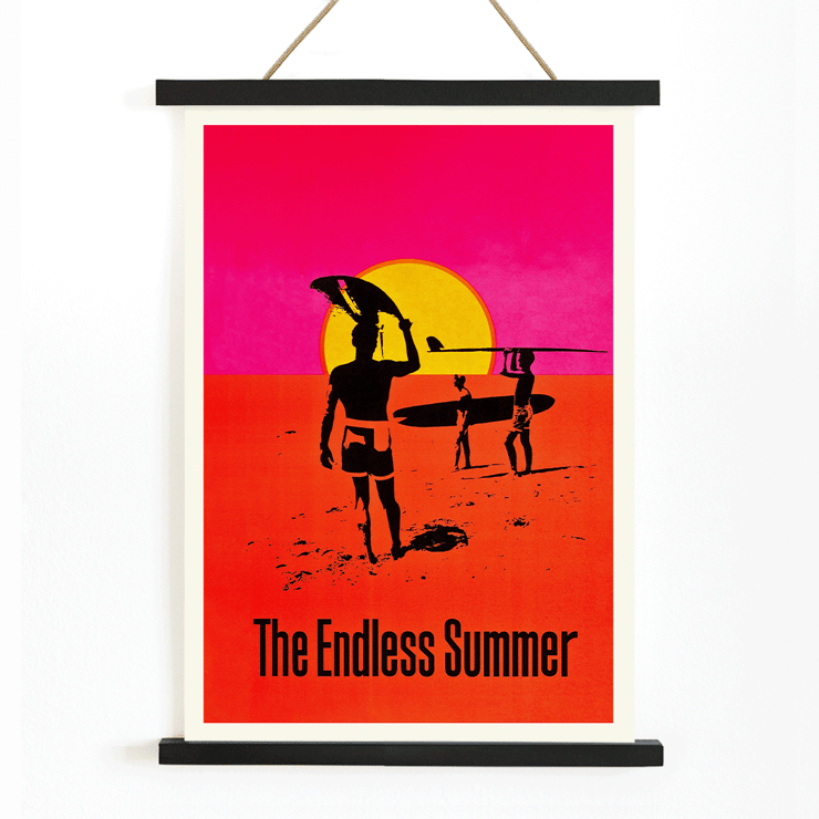 The Endless Summer surfers walking on beach at sunset Poster featuring surfers carrying boards against a stylized sunset backdrop titled The Endless Summer