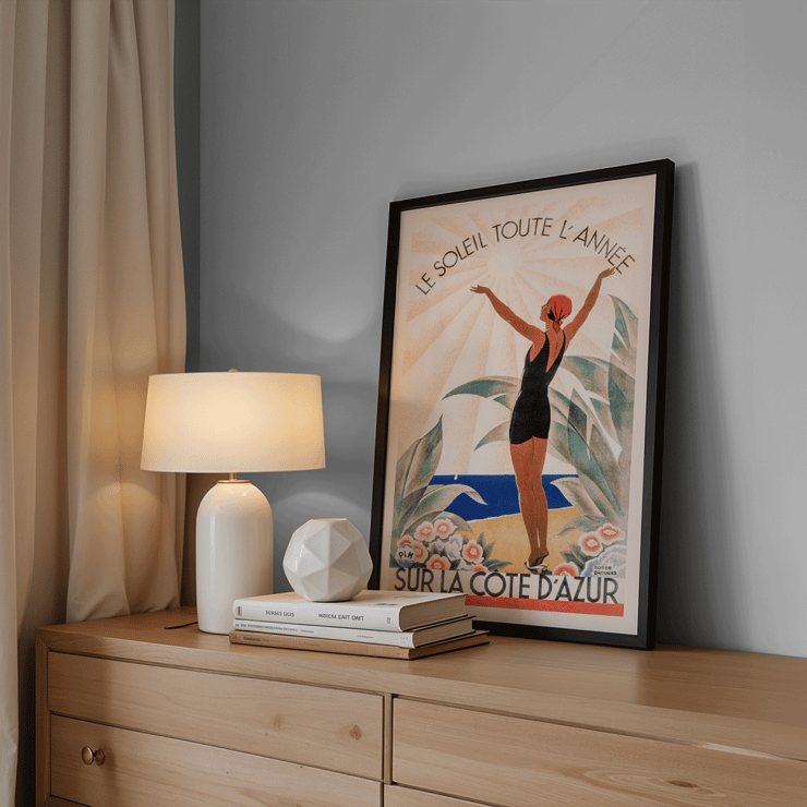 Woman enjoying sunny beach scenery Cote d'Azur by Roger Broders. Poster of a woman in a swimsuit with arms raised at the beach surrounded by flowers Artwork Cote d'Azur by Roger Broders