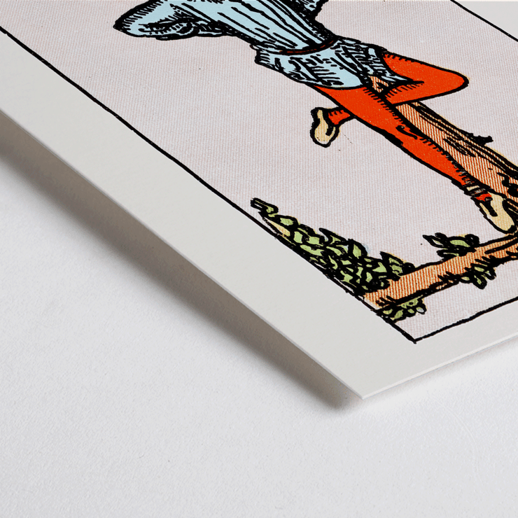 The Hanged Man tarot card by Rider Waite featuring a figure suspended upside-down from a wooden post. Poster depicting Tarot - The Hanged Man by Rider Waite showing a man hanging upside down by one leg from a wooden structure