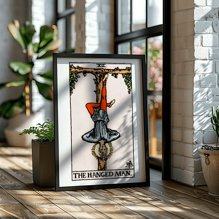 The Hanged Man tarot card by Rider Waite featuring a figure suspended upside-down from a wooden post. Poster depicting Tarot - The Hanged Man by Rider Waite showing a man hanging upside down by one leg from a wooden structure
