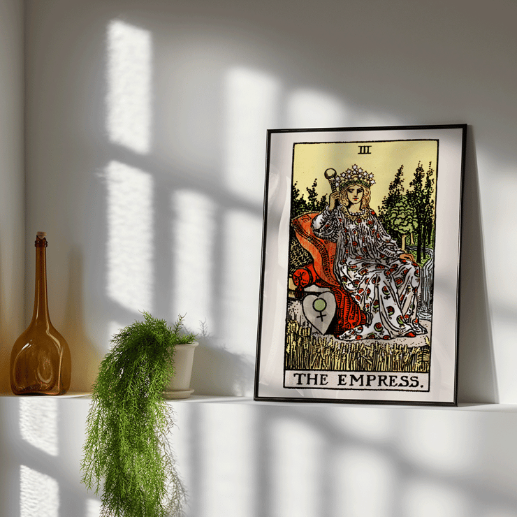 Colorful Tarot card The Empress by Rider Waite featuring a crowned woman sitting on a throne in a lush natural setting. Poster of Tarot - The Empress by Rider Waite showing a woman seated on a throne with a crown of stars, holding a scepter.