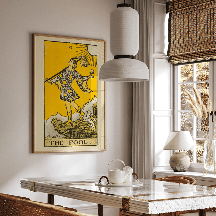 The Fool tarot card illustration by Lauron William de Laurence featuring a whimsical character and a small dog on a cliff. The Fool tarot card poster by Lauron William de Laurence depicts a figure on a cliff with a dog beneath a bright yellow background.